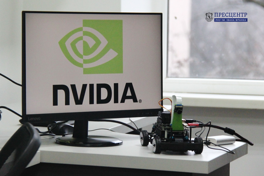 Robotics prototype near a monitor with the NVIDIA logo